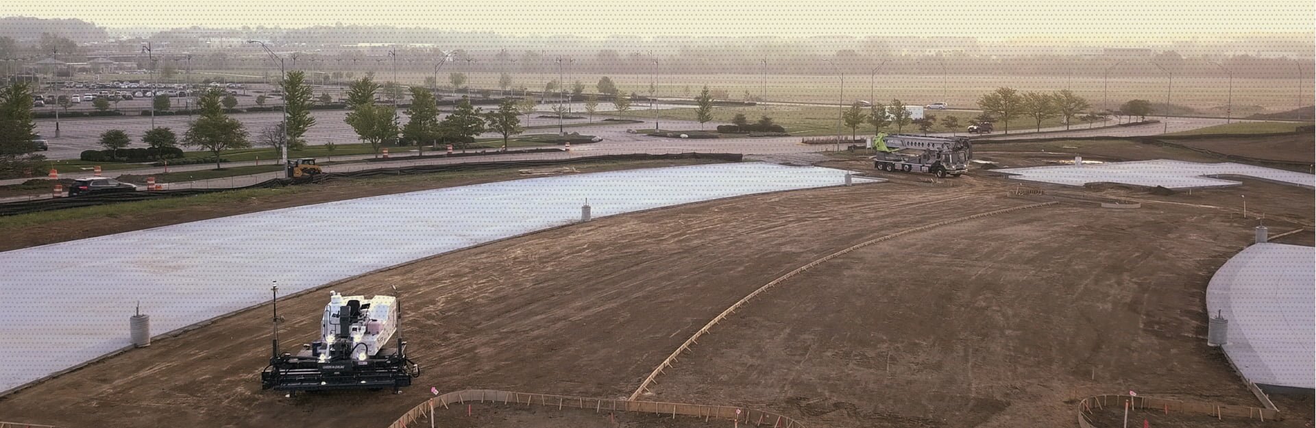 An AM Contracting site that is vast as most of it still requires concrete and a partial area that already has concrete smoothed down and prepared.