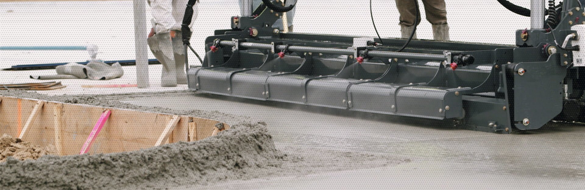 Using Laser Screed technology, the AM Contracting crew creates a flawless concrete foundation structure as the employees analyze the process close up.